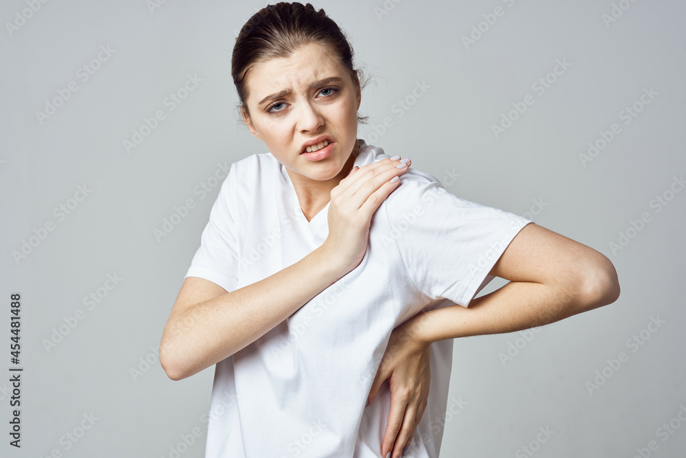 disgruntled woman in white t-shirt joint pain health problems emotions disgruntled woman in white t-shirt joint pain health problems emotions