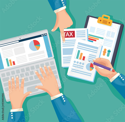 Hands with tax document and laptop