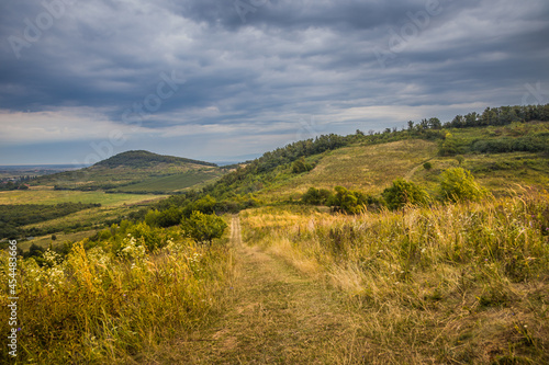 Wallpaper Mural Dawn in the mountains. Path in the mountains at dawn.The sun rises from behind the mountains. Beautiful green and yellow hills. A colorful cloudy sky. Mountains in the fog. Carpathian, Ukraine, Torontodigital.ca