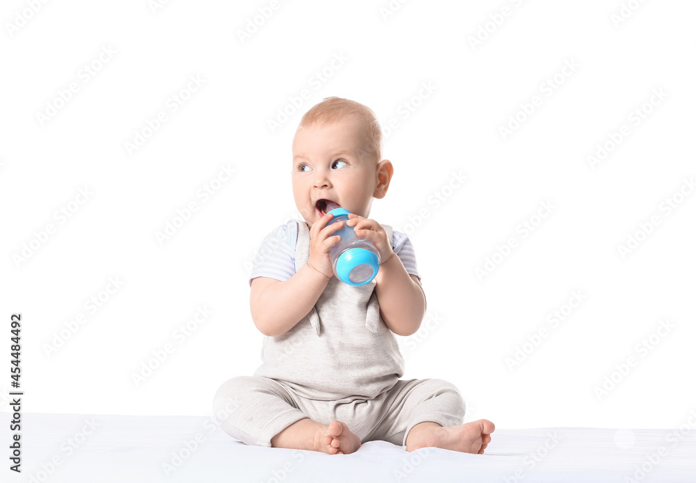 Cute little baby drinking water from bottle on white background Cute little baby drinking water from bottle on white background