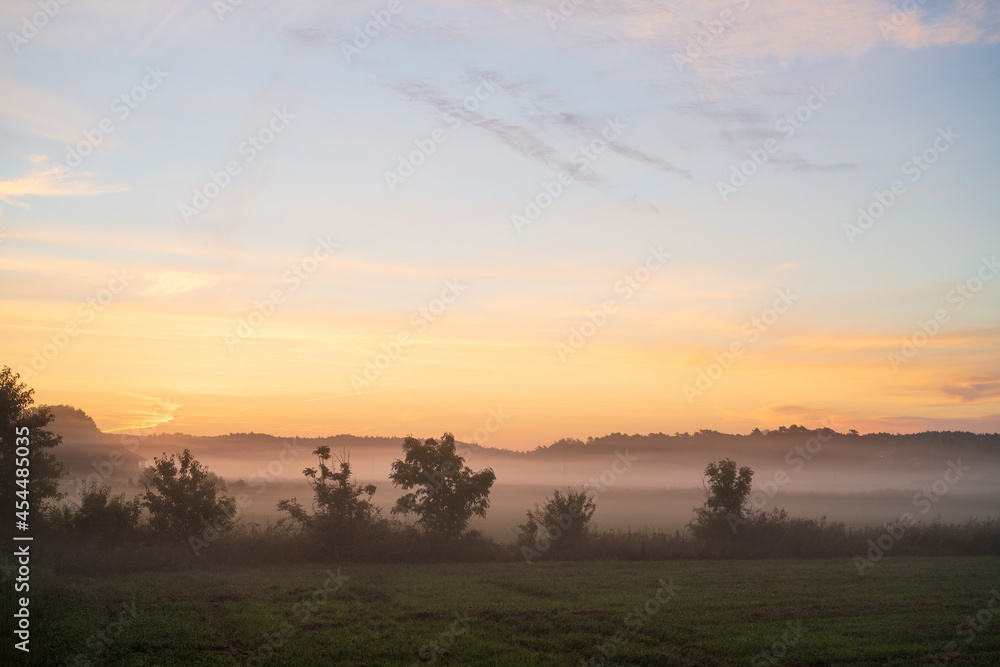 Misty morning sunrise over the field