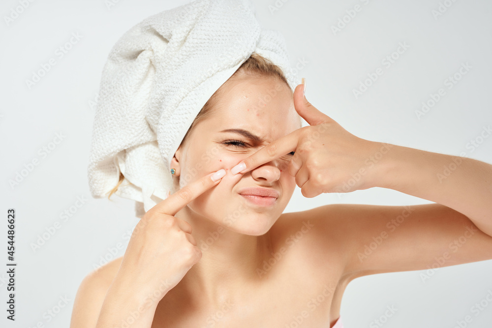 woman with bare shoulders squeezes out pimples on dermatology discontent face woman with bare shoulders squeezes out pimples on dermatology discontent face