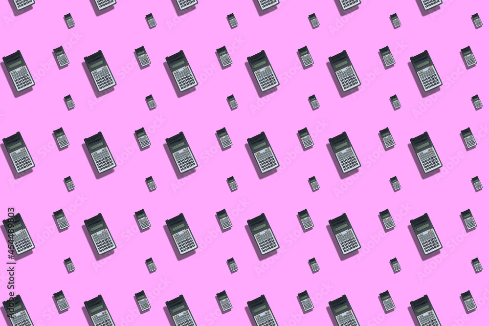 Geometric composition with repeating scientific calculators on Pink pastel background. Science, business, calculations.