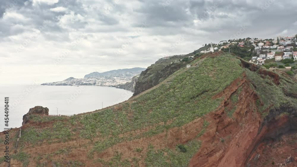 Madeira Islands, Portugal. High steep slope covered with green, lush vegetation. Aerial footage of a monument on a viewpoint with a magnificent landscape. High quality 4k footage Madeira Islands, Portugal. High steep slope covered with green, lush vegetation. Aerial footage of a monument on a viewpoint with a magnificent landscape. High quality 4k footage