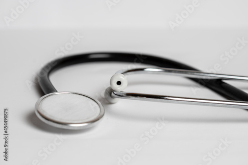 Medical black stethoscope on a white background