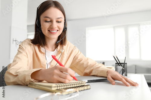 Young woman writing somethi...