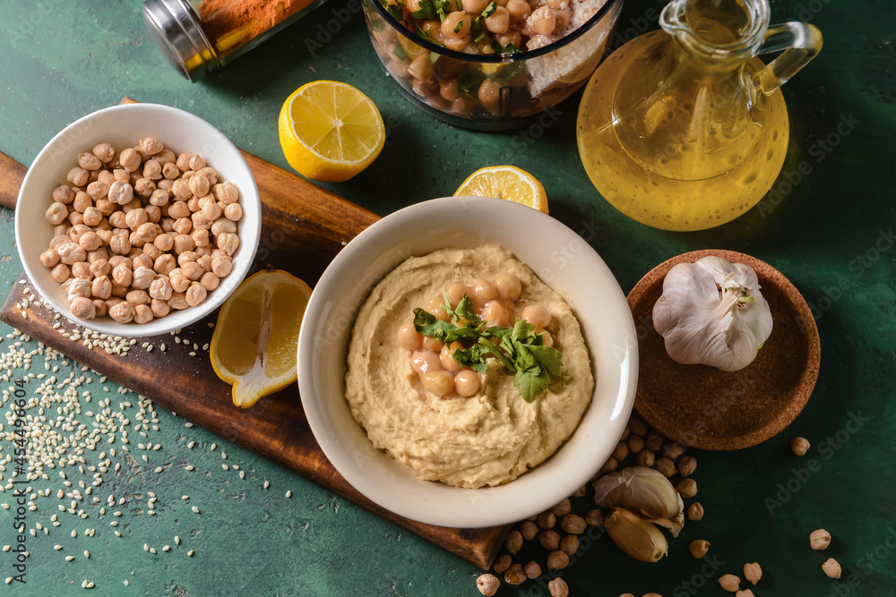 Composition with tasty hummus and ingredients on color background
