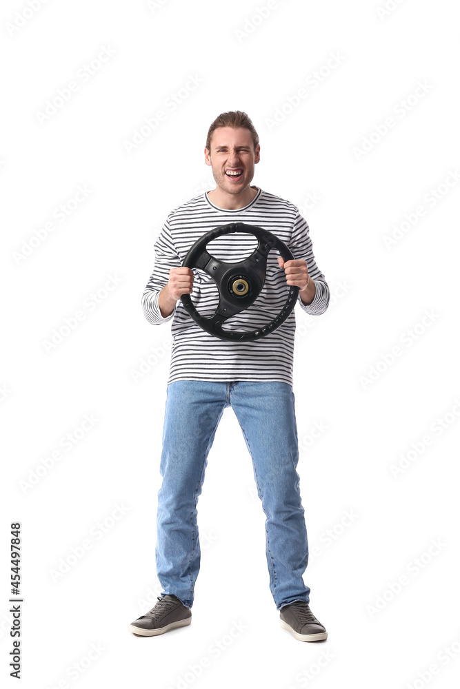 Angry young man with steering wheel on white background Angry young man with steering wheel on white background