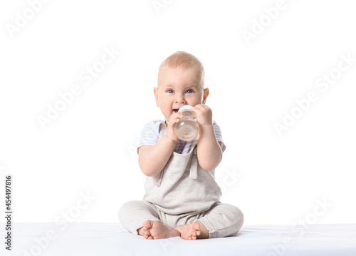 Cute little baby drinking water from bottle on white background