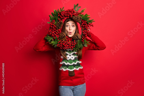 Photo of cool young lady look door decoration wear holiday sweater isolated on red color background