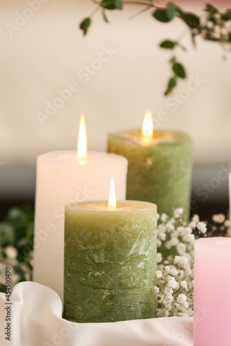 Burning candles and gypsophila flowers, closeup