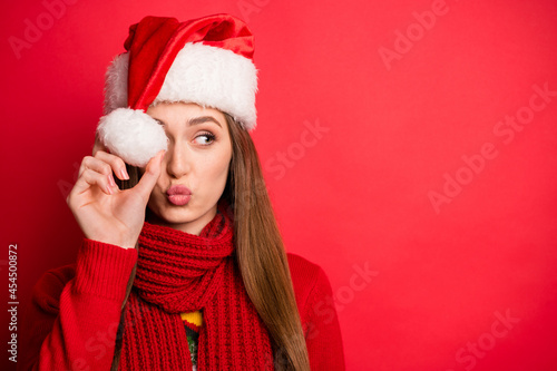 Photo of coquette millennial lady hold cap blow kiss wear holiday sweater scarf isolated on red color background