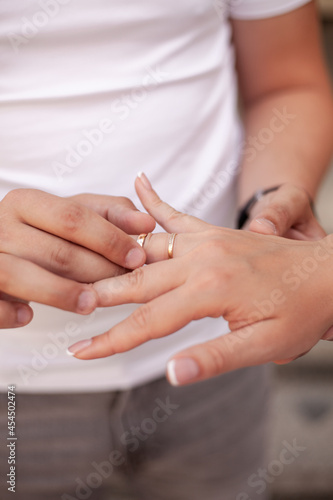 beautiful hands of the bride and groom exchange wedding rings during the wedding ceremony. 