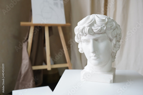 David's head sculpture on the table . Home interior decor room for art