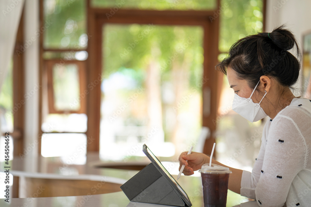 Young woman using tablet working indoor. Work from home concept. Young woman using tablet working indoor. Work from home concept.