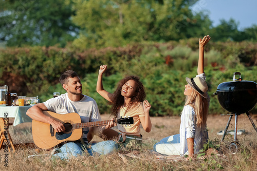 Young man playing guitar at...
