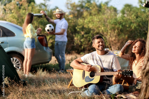 Young man playing guitar at...