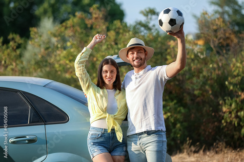 Young couple with ball at b...