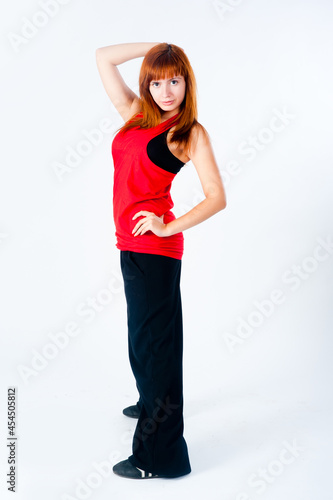 Young beatiful woman dancing hip-hop at white background