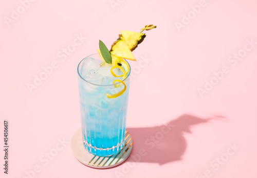 Glass of Blue Lagoon cocktail on color background