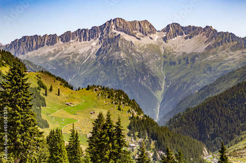 Sunny mountain with waterfall in alps