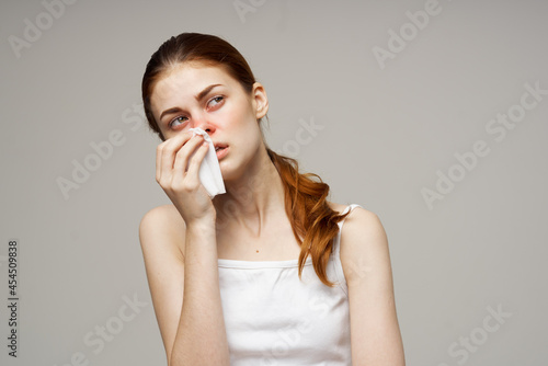 sick woman in white t-shirt with a scarf isolated background