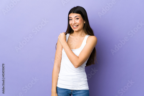 Young brunette woman over isolated purple background celebrating a victory © luismolinero