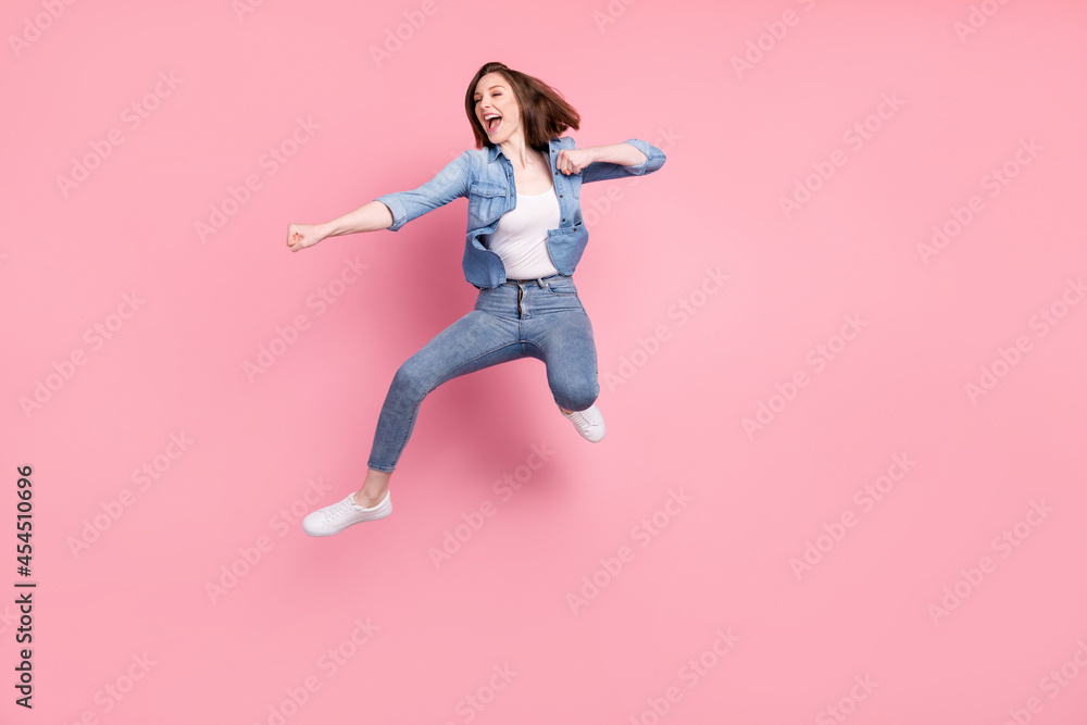 Full length body size photo girl jumping practising karate looking copyspace isolated pastel pink color background