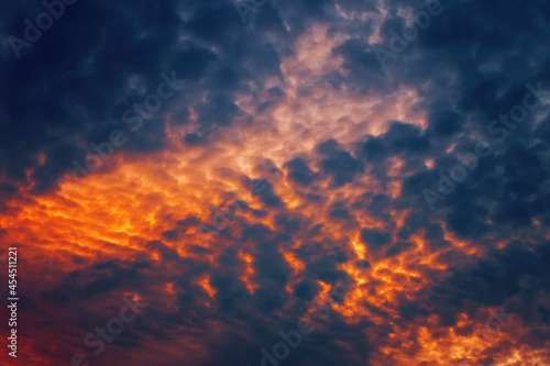 Fire in the sky. Orange and dark blue clouds like flowing volcanic lava. Great abstract texture in bright colors for your design.