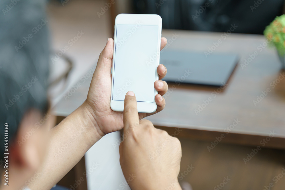 Mockup image of man's hands holding white mobile phone with blank screen in cafe,copy space on smart phone for advertisement. Mockup image of man's hands holding white mobile phone with blank screen in cafe,copy space on smart phone for advertisement.