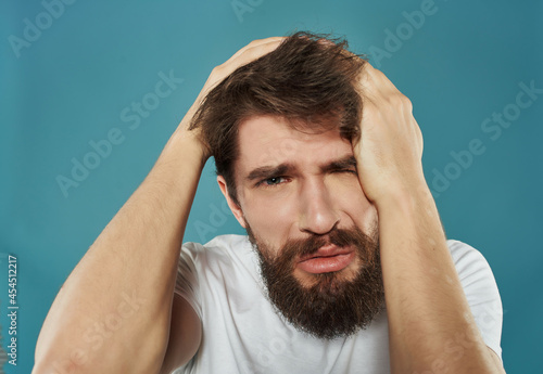 bearded man in a white t-shirt hand gestures anger Studio