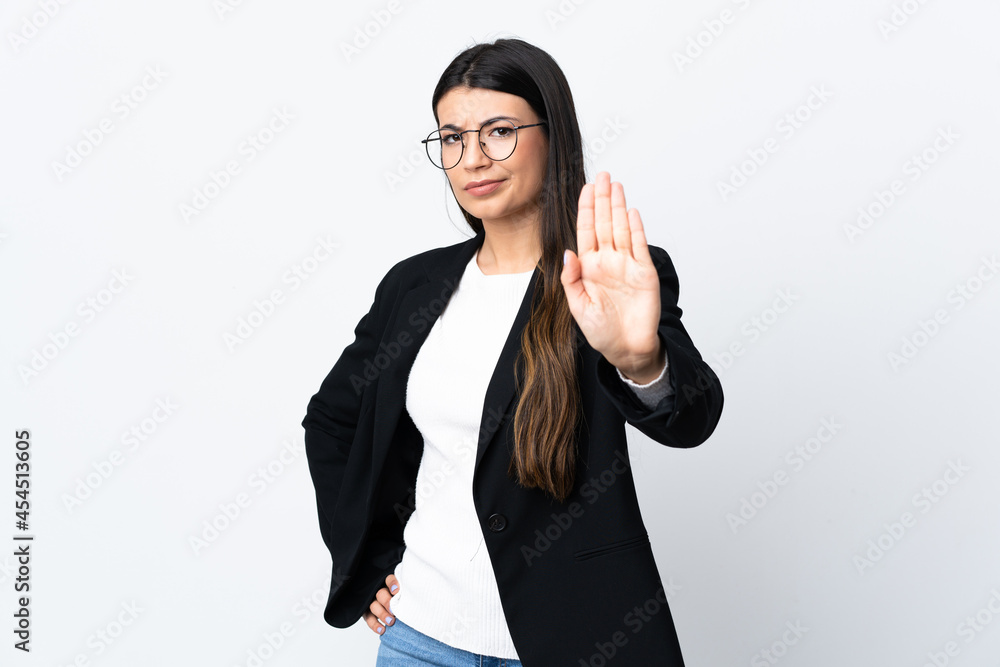 Business woman over isolated white background making stop gesture with her hand Business woman over isolated white background making stop gesture with her hand