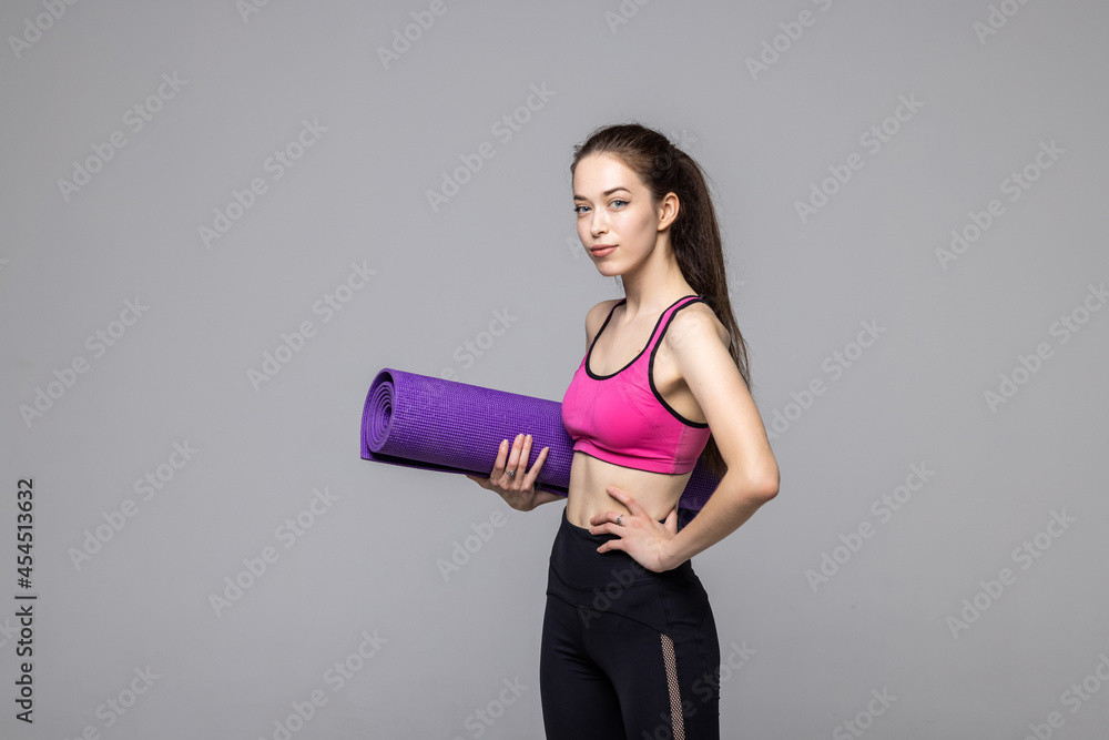 Young Woman Holding Exercise Mat Isolated On White Background Young Woman Holding Exercise Mat Isolated On White Background