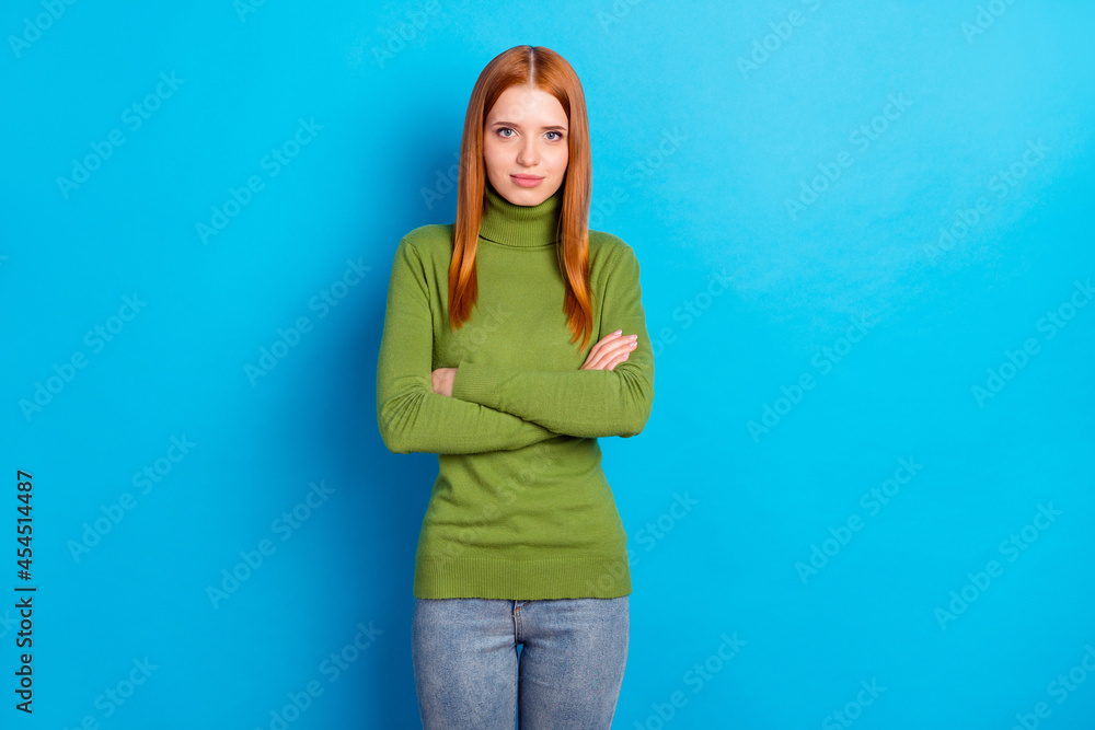 Portrait of pretty positive young girl folded arms look camera have good mood isolated on blue color background Portrait of pretty positive young girl folded arms look camera have good mood isolated on blue color background