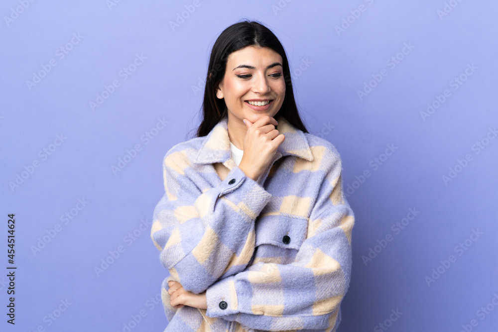 Young brunette woman over isolated purple background looking to the side Young brunette woman over isolated purple background looking to the side