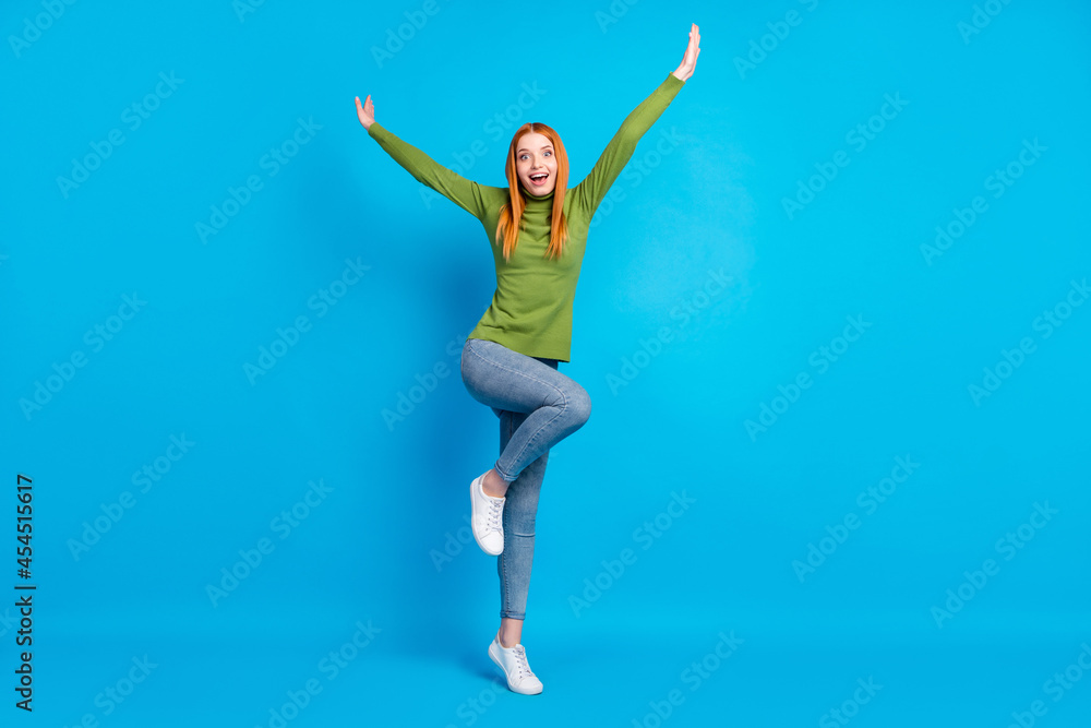 Full length body size view of attractive cheerful girlish funny girl jumping fooling isolated over bright blue color background Full length body size view of attractive cheerful girlish funny girl jumping fooling isolated over bright blue color background