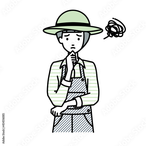 立って手をあごにあてて困っている農家の女性