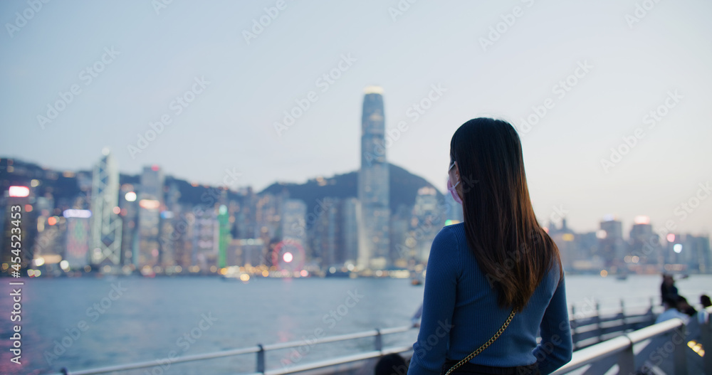 Woman enjoy the view of Hong Kong at sunset