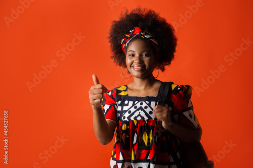 consent of beautiful african woman in traditional dress on red background 