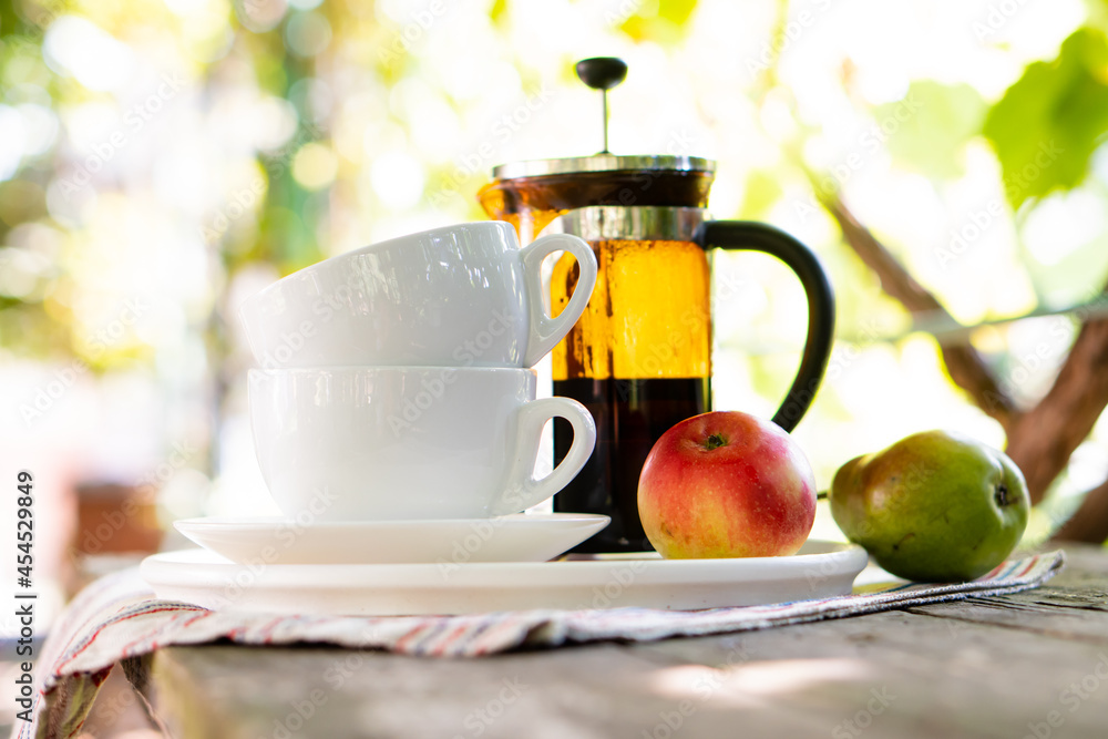 Breakfast serving for two, tea cups and fruits Breakfast serving for two, tea cups and fruits