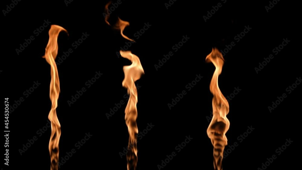 Three flames alternately light up and glow an orange yellow fire against black background. Real bonfire, burner or torch flares up in the dark. Fire glow, dangerous blazing fire close up. Slow motion. Three flames alternately light up and glow an orange yellow fire against black background. Real bonfire, burner or torch flares up in the dark. Fire glow, dangerous blazing fire close up. Slow motion.