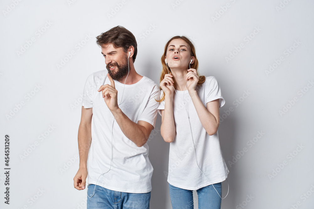 young couple in white t-shirts and jeans casual wear fun positive young couple in white t-shirts and jeans casual wear fun positive