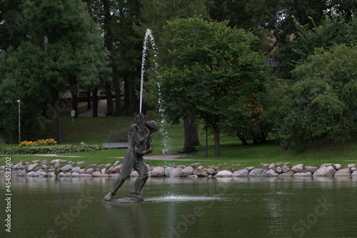 Photography FOUNTAIN IN NATURE PARK WITH BEAUTIFUL STONE PAVED EDGE
