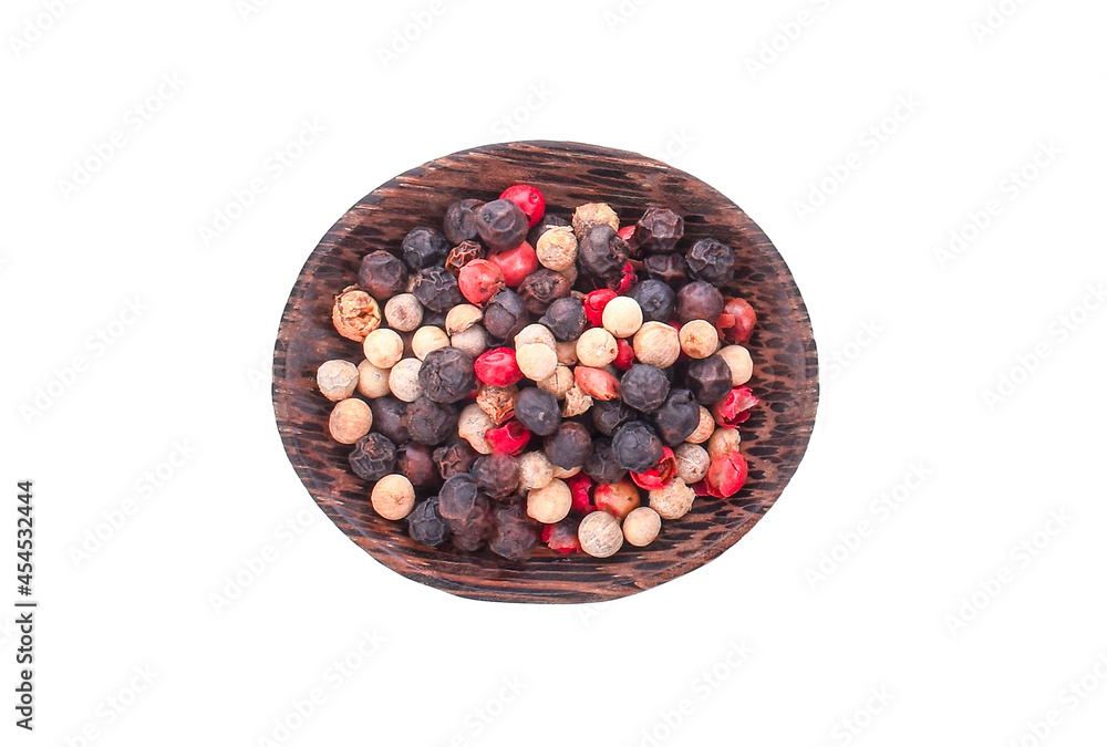 Mixed Red, Black and White Peppercorn in Wooden bowl on white background. Mixed Red, Black and White Peppercorn in Wooden bowl on white background.