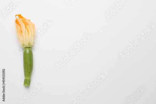 Zucchini and zucchini flowers on white background 