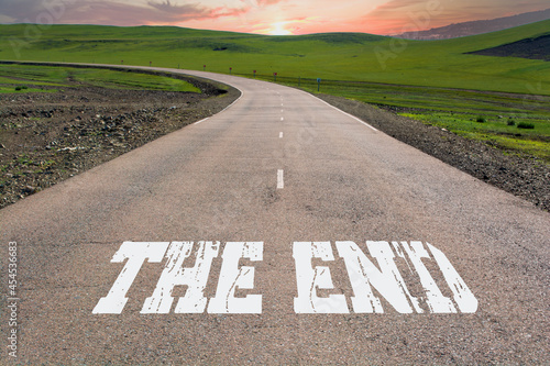 The End written on rural road