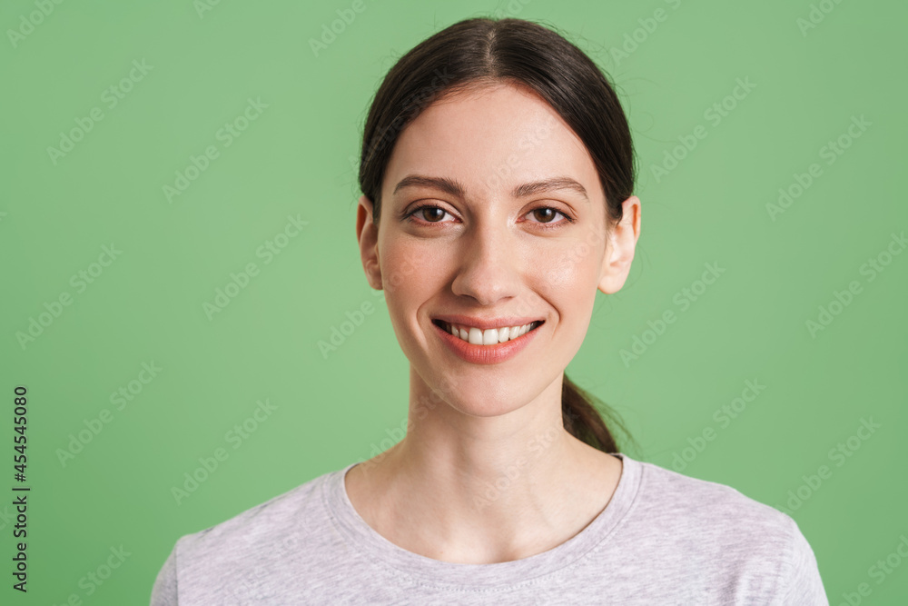Young brunette woman looking and smiling at camera Young brunette woman looking and smiling at camera