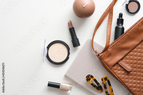 Make-up cosmetic bag on white background. Glamour makeup artist pouch with beauty products. Flat lay, top view