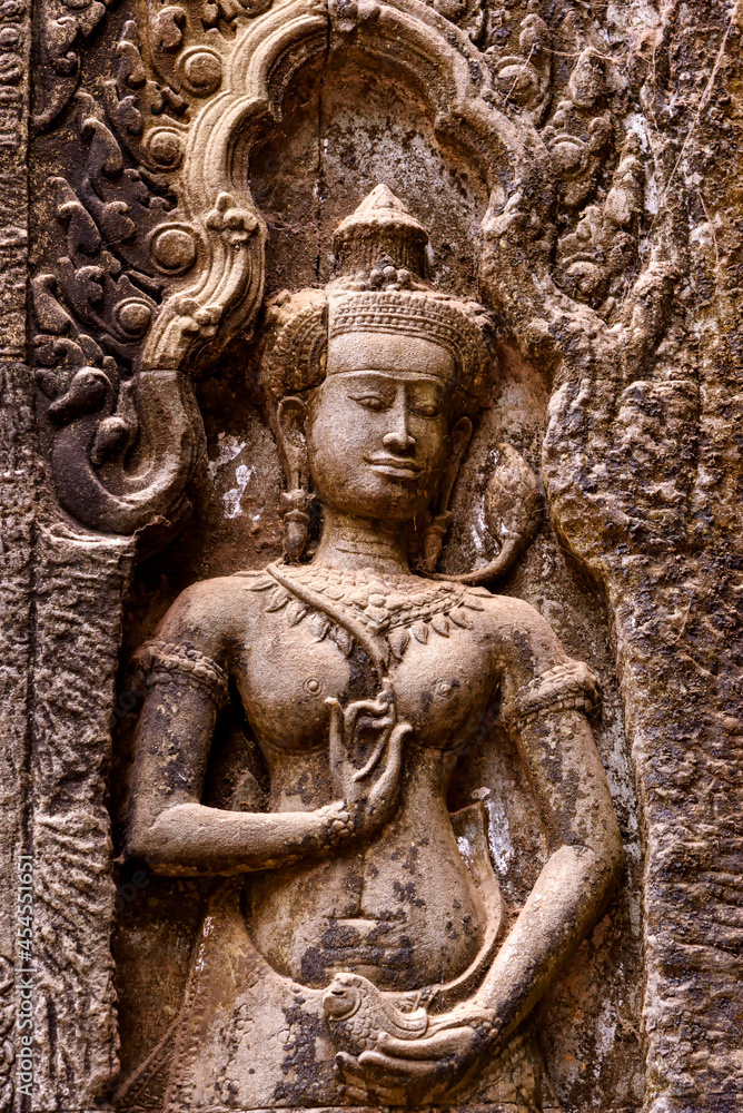 Detail of bas relief sculpture the wall of the ancient Ta Prohm temple in the Angkor Thom Area, Siem Reap, Cambodia.