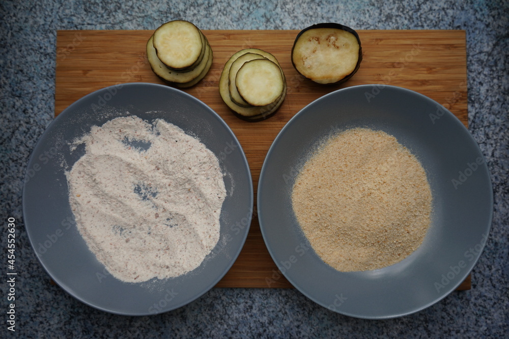 vegan crispy eggplant slices about to get breaded with breadcrumbs and flour vegan crispy eggplant slices about to get breaded with breadcrumbs and flour